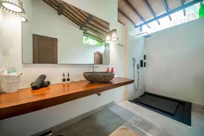 a bathroom with a bowl sink on a wooden counter at Villa Kuda Sumba Umalas - Seminyak Area in Kerobokan