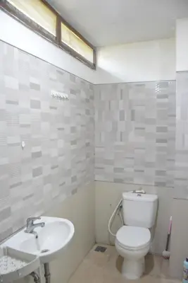 a bathroom with a toilet and a sink at Bracha house in Legian