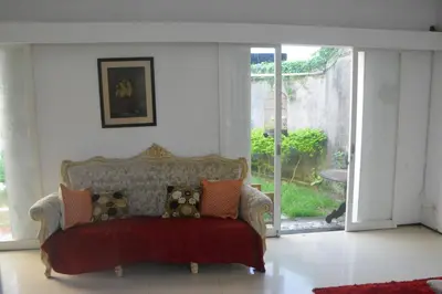 a living room with a couch with pillows on it at Bracha house in Legian