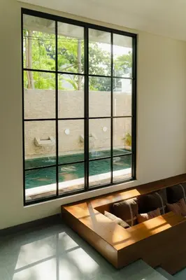 a living room with a couch and a large window at LUX Casa Amore 4BR pick up from airport security PlayStation and Netflix in Seminyak