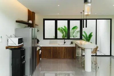 a kitchen with a refrigerator and a sink in it at LUX Casa Amore 4BR pick up from airport security PlayStation and Netflix in Seminyak