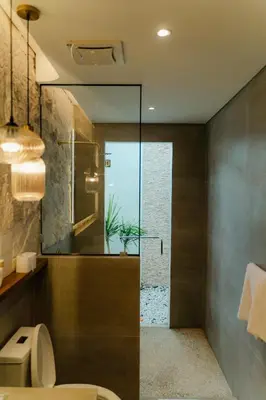 a bathroom with a toilet and a glass shower at LUX Casa Amore 4BR pick up from airport security PlayStation and Netflix in Seminyak