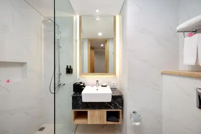 a bathroom with a sink and a glass shower at Anagata 2 Tanjung Benoa Bali in Nusa Dua