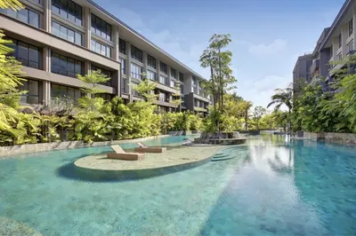 a swimming pool in front of a building at Anagata 2 Tanjung Benoa Bali in Nusa Dua