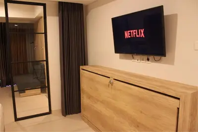 a flat screen tv on a wall in a room at Anagata 2 Tanjung Benoa Bali in Nusa Dua