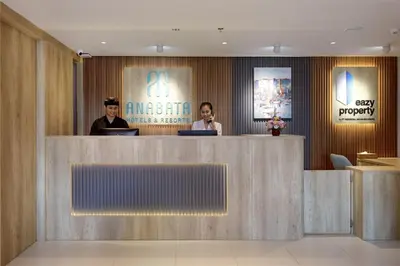 two people sitting at a counter in a lobby at Anagata 2 Tanjung Benoa Bali in Nusa Dua