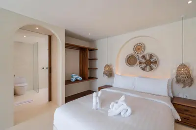 a bedroom with a white bed with towels on it at Casa Melosa 1 - Romantic and Cozy 1BR Villa in the Heart of Umalas in Canggu