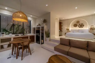 a bedroom with a bed and a table and a couch at Casa Melosa 2 : Charming and Intimate 1BR Villa Nestled in Umalas in Canggu
