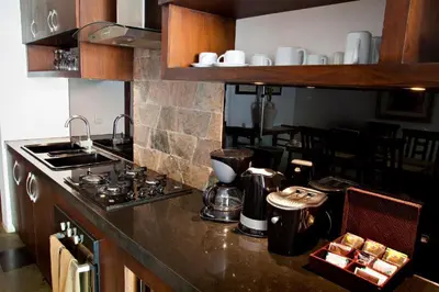 a kitchen with a stove and a counter top at Sujiwana 2BR Luxury Jungle Pool View Villa CYN in Jimbaran