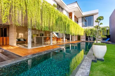 an infinity pool in the backyard of a house at Villa Eighty8 Private Residence with Gym & 20m Pool in Kerobokan