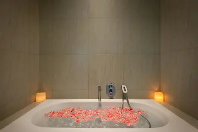 a bathroom with a bath tub filled with red sprinkles at Villa Eighty8 Private Residence with Gym & 20m Pool in Kerobokan
