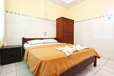 a bedroom with a bed with towels on it at Gora Beach Inn in Kuta