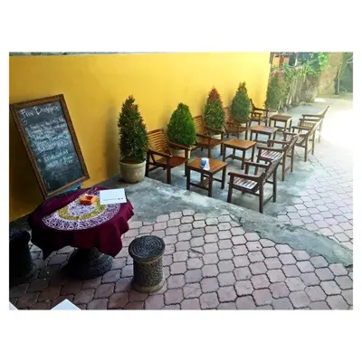 a row of tables and chairs in a restaurant at Gora Beach Inn in Kuta