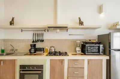 a kitchen with a stove and a microwave at 3 Bedroom cozy private pool Villa in Seminyak WIFI in Seminyak