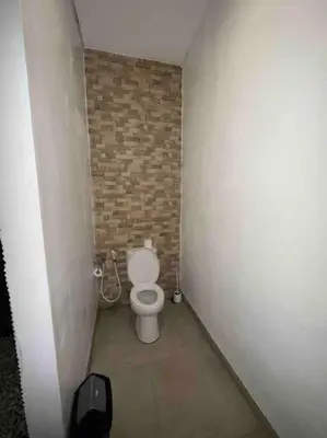 a small bathroom with a toilet in a brick wall at UMARA villa bali x villa aydin kerobokan bali in Seminyak
