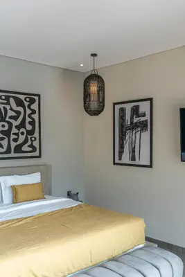 a bedroom with a bed and a pendant light at Villa Koya : Luxurious and Modern 3BR Villa in Seminyak! in Seminyak