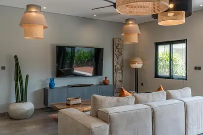 a living room with two couches and a tv at Villa Koya : Luxurious and Modern 3BR Villa in Seminyak! in Seminyak