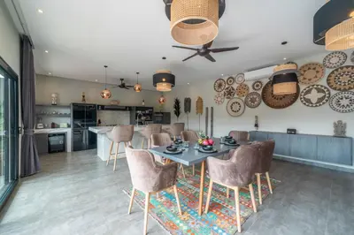 a kitchen and dining room with a table and chairs at Villa Koya : Luxurious and Modern 3BR Villa in Seminyak! in Seminyak