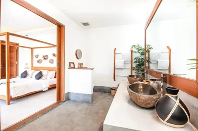 a bedroom with a bed and a large mirror at Spectacular 4BR Villa, 400m to Beachfront Bliss in Canggu