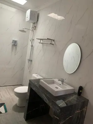 a bathroom with a sink and a mirror and a toilet at Melza room no.3 in Kerobokan