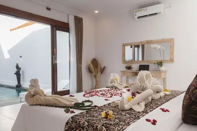 a bedroom with a bed with stuffed animals on it at Maisaba Seminyak Loft & Villas in Seminyak