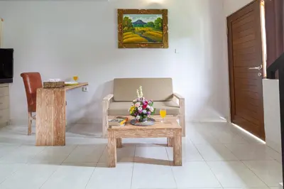 a living room with a table with flowers on it at Maisaba Seminyak Loft & Villas in Seminyak