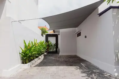 a hallway of a house with white walls and a staircase at Maisaba Seminyak Loft & Villas in Seminyak