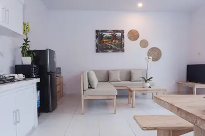 a living room with a couch and a table at Maisaba Seminyak Loft & Villas in Seminyak
