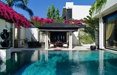 a swimming pool in front of a house with a gazebo at Villa One Seminyak in Seminyak