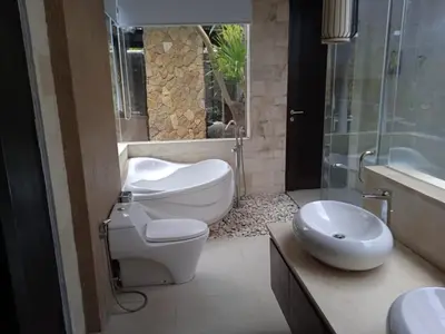 a bathroom with a toilet and a sink at Villa Samatha in Nusa Dua