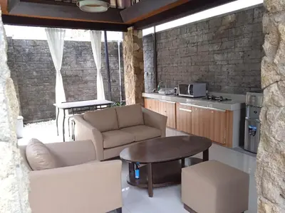a living room with two couches and a table at Villa Samatha in Nusa Dua