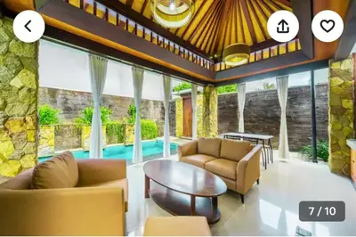 a living room with two couches and a table at Villa Samatha in Nusa Dua