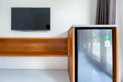 a flat screen tv sitting on top of a cabinet at Aldan Guest House Syariah in Pesanggaran