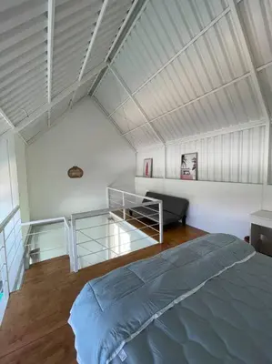 a bedroom with a large bed and a staircase at Monty’s Villa Umalas - 1 Bedroom in Kerobokan