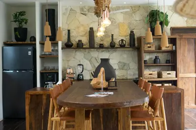 a dining room with a wooden table and chairs at Villa Senya - Bali Bliss 3BR Mediterranean Escape with Private Pool, Stylish Retreat Between Seminyak & Canggu in Kerobokan