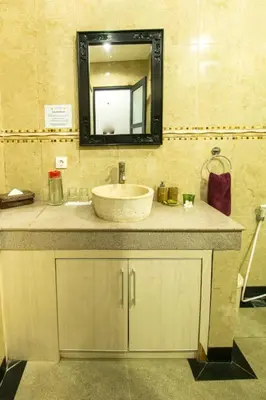 a bathroom with a sink and a mirror at Villa cinta buana 1 in Legian