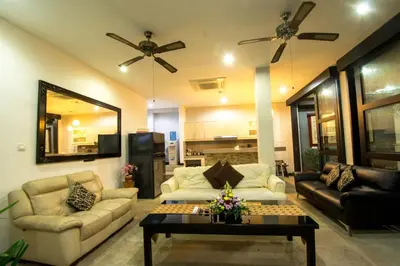 a living room with a couch and a table at Villa cinta buana 1 in Legian