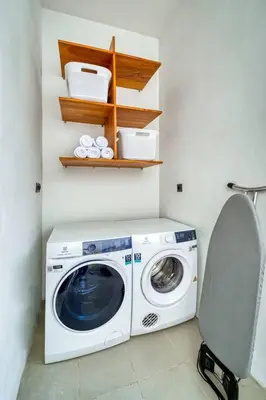 a washer and dryer in a small room with at Beautiful villa Yang Tao in the heart of Seminyak with private staff in Seminyak