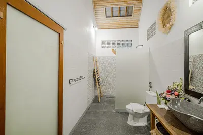 a bathroom with a toilet and a sink at Villa Miamara by Bali Villa Solutions in Seminyak