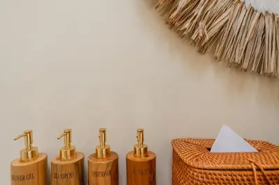 four bamboo toothbrushes in a row next to a basket at Villa Nana by Pertama Management in Seminyak