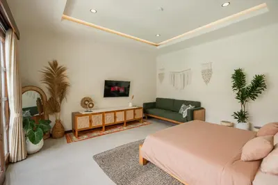 a living room with a bed and a couch at Villa Nana by Pertama Management in Seminyak