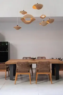 a dining room with a wooden table and chairs at Villa Talisman - Luxury Rooftop Canggu Villa Only 5 mins to Beach in Canggu