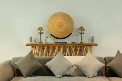 a living room with a couch and a basket on the wall at Villa Talisman - Luxury Rooftop Canggu Villa Only 5 mins to Beach in Canggu