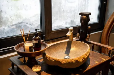a bathroom with a bowl sink and a statue at Casa Madi Canggu in Canggu