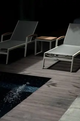 two chairs and a table on a wooden deck at Villa Talisman - Stylish Canggu with Rooftop Villa 5 mins to Beach in Canggu