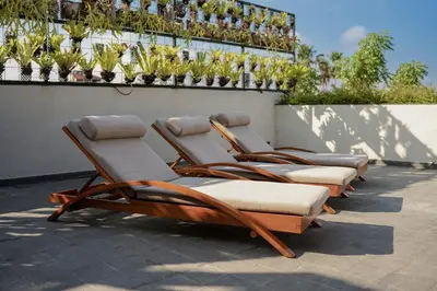 four lounge chairs lined up against a wall at Sedasa Lodge in Canggu