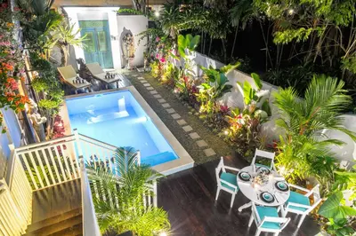 an overhead view of a swimming pool in a garden at Selasih Beach House in Seminyak