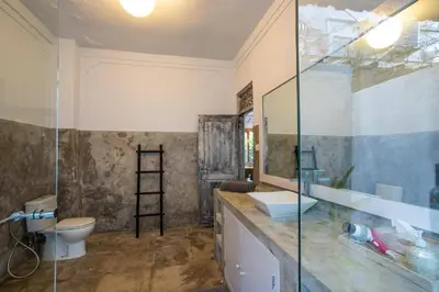 a bathroom with a glass shower and a toilet at Villa Dolcevita Seminyak in Seminyak