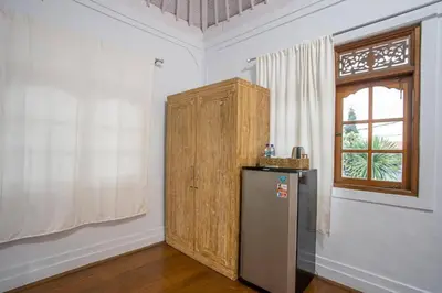 a kitchen with a refrigerator and a window in a room at Villa Dolcevita Seminyak in Seminyak