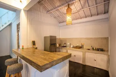 a large kitchen with a counter and a refrigerator at Villa Dolcevita Seminyak in Seminyak